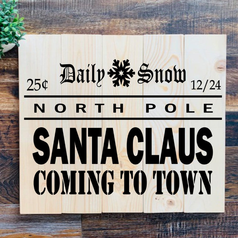 Wooden sign with 'Daily Snow' and 'Santa Claus Coming to Town' text on a wooden background