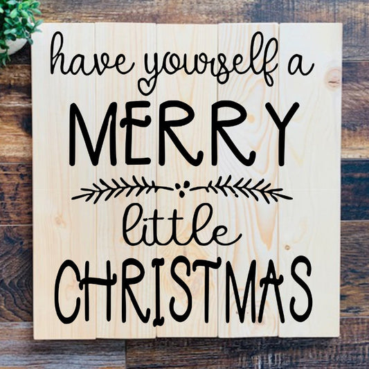 Wooden sign with 'have yourself a merry little Christmas' text on a wooden background