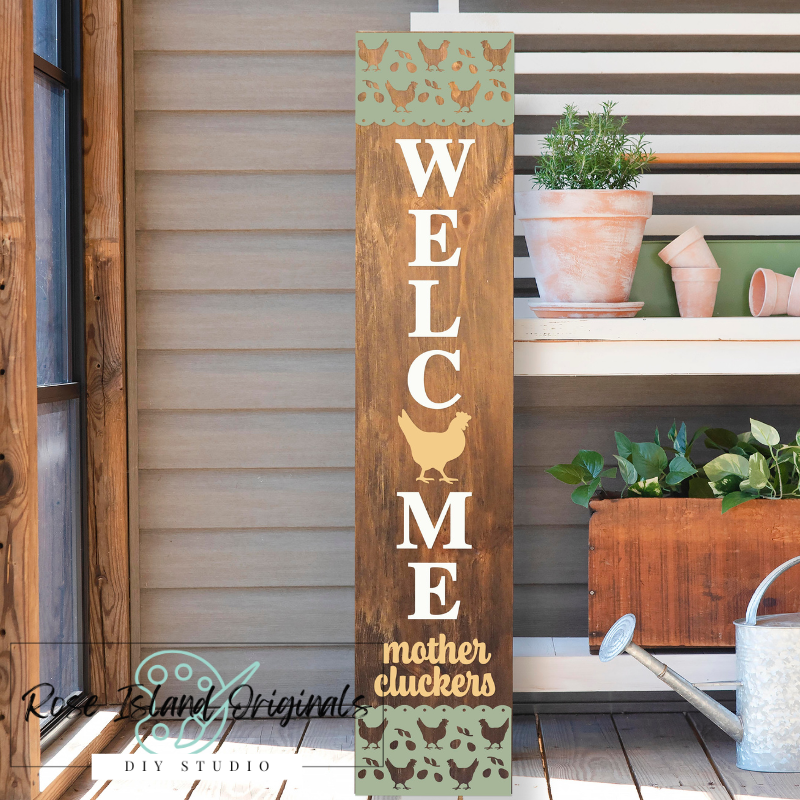 Wooden sign with 'Welcome mother cluckers' text on a wooden deck.