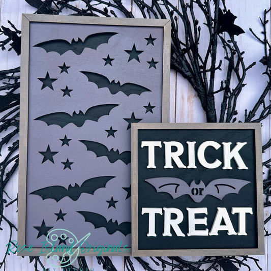 Halloween-themed decorative signs with bats and 'Trick or Treat' text on a dark background.